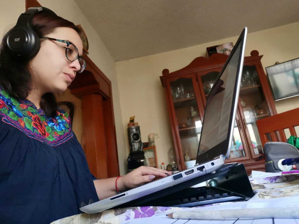 A woman in Mexico does media monitoring on her laptop