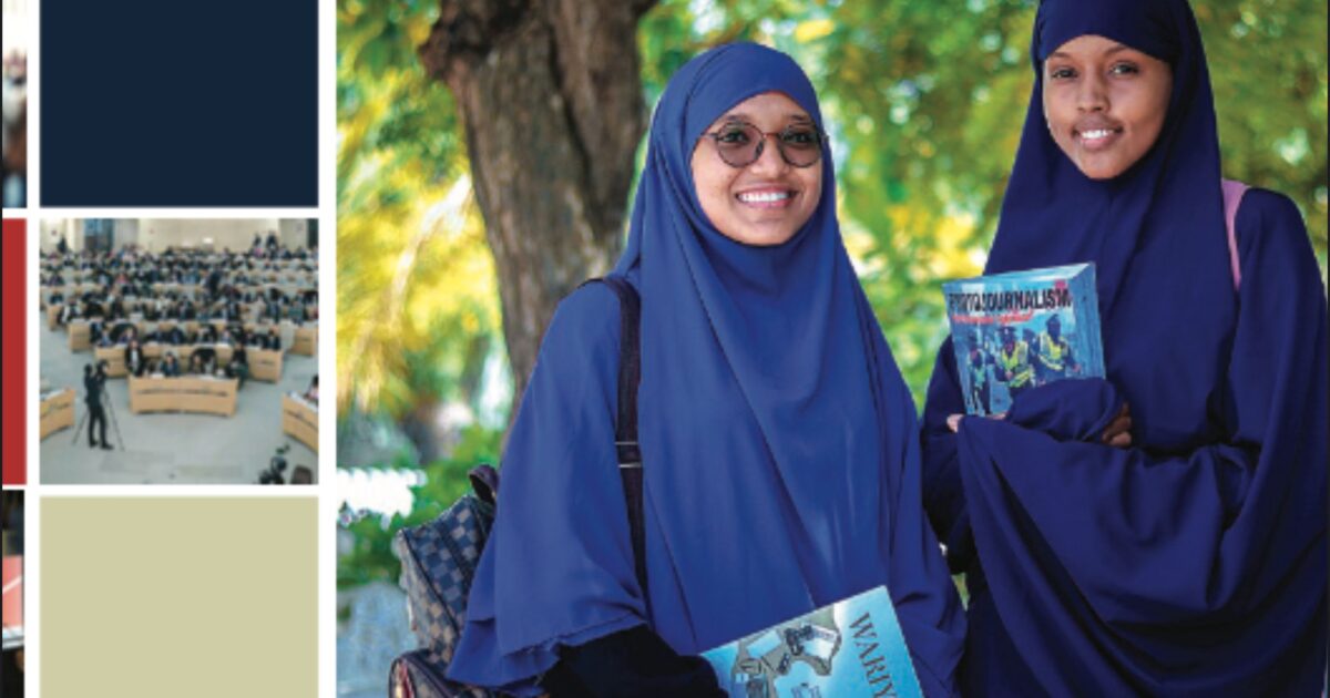 Two young women wearing headscarves hold magazines