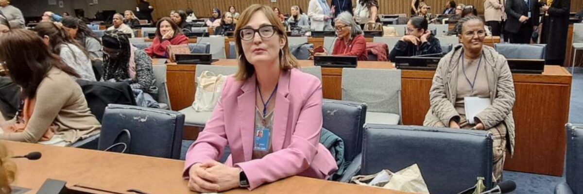 Abida Pehlic sits at a table in an auditorium at the UN with other CSW70 attendees around her